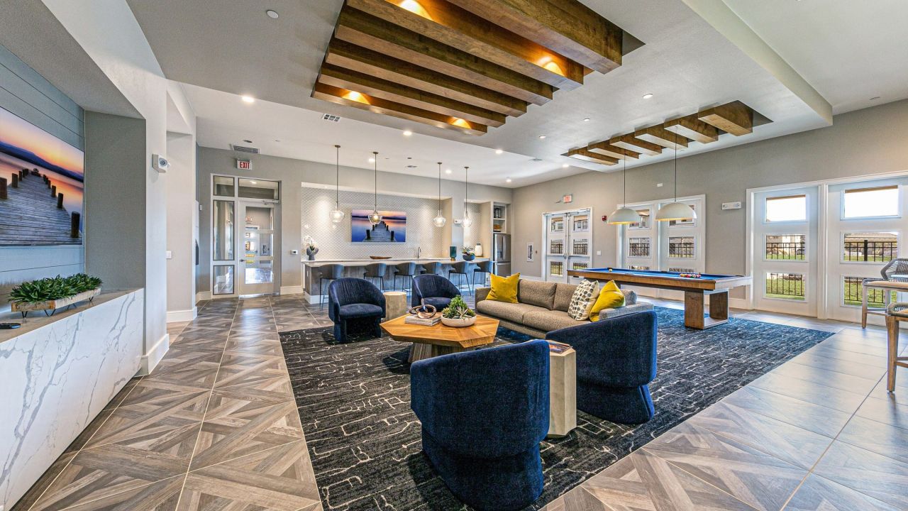 Hawthorne at Bay Forest resident clubhouse amenity with seating area, full kitchen and billiards table